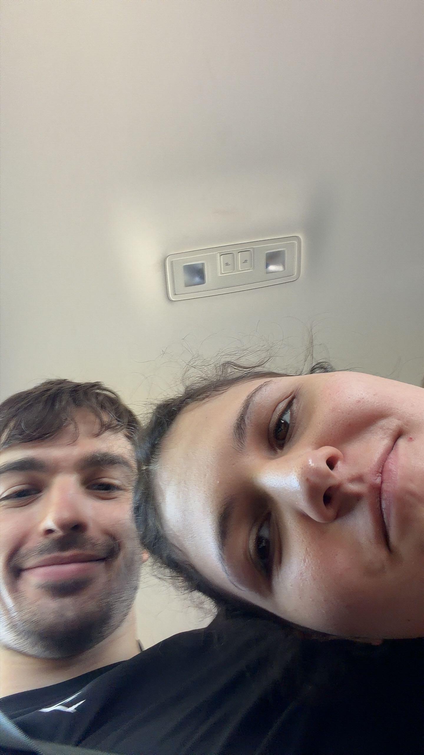 A close, tilted selfie of Asya and Jan indoors
