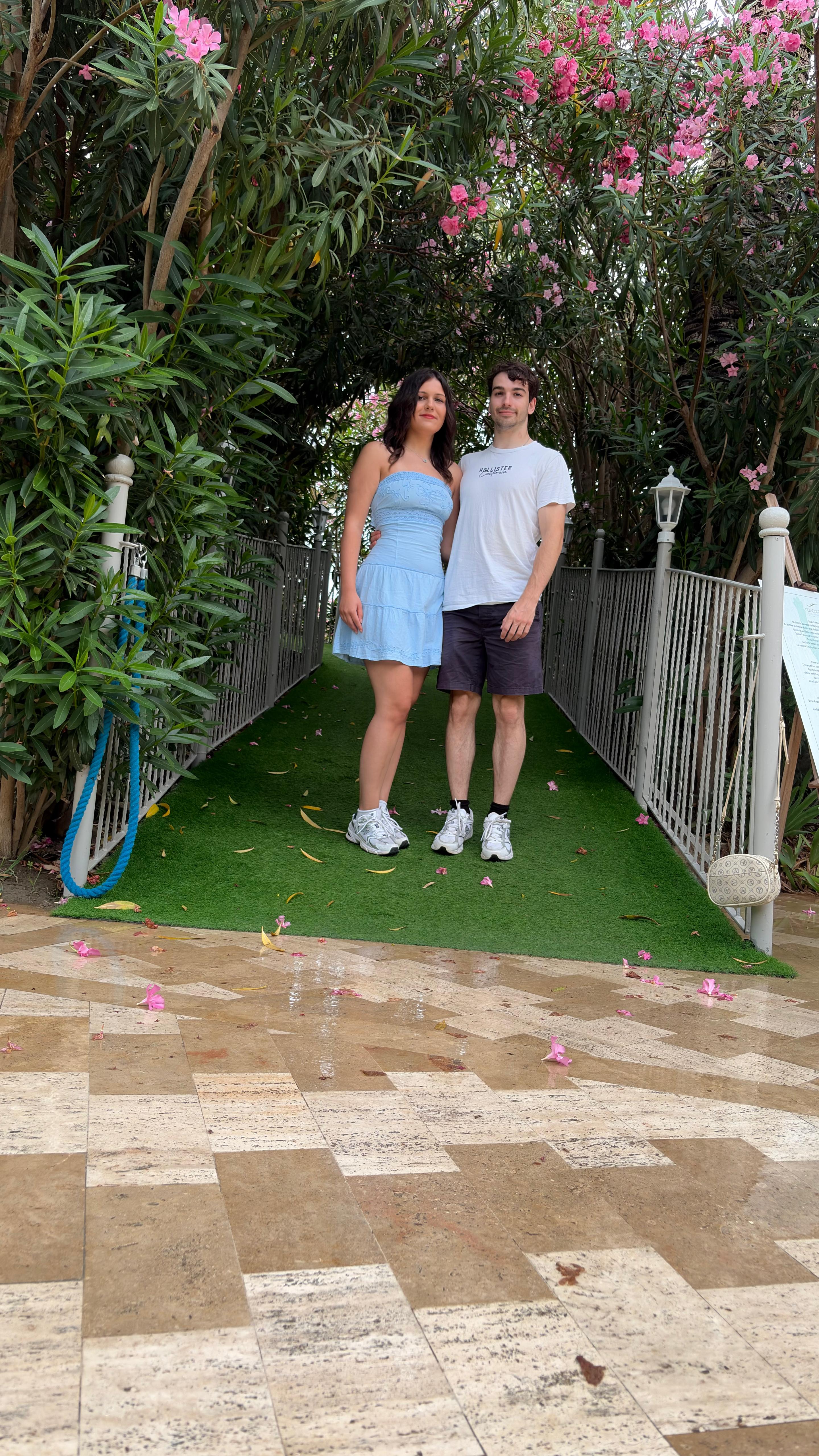 Asya and Jan standing under flowering oleanders